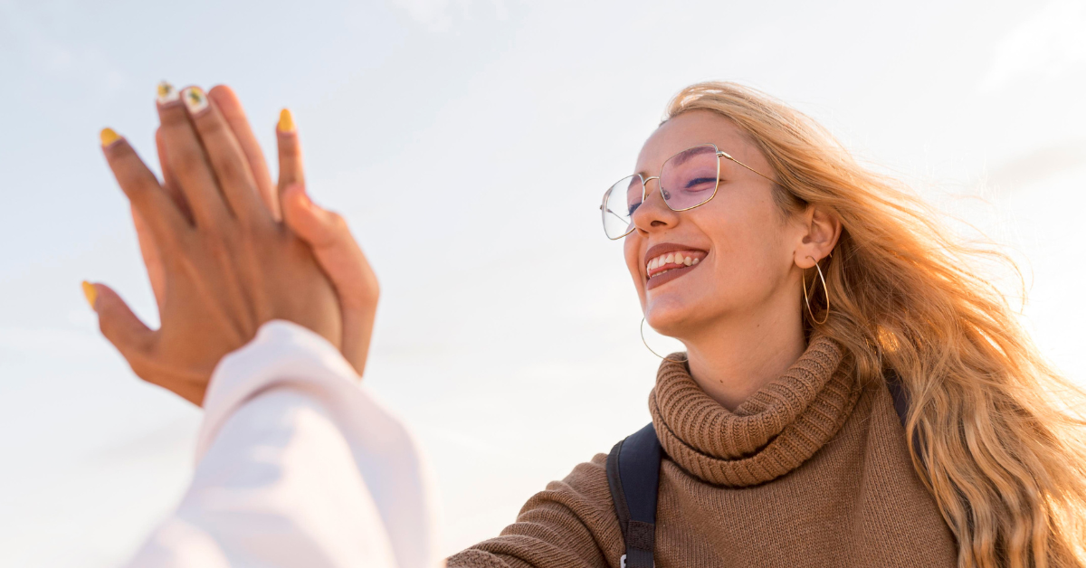 two people in recovery high-fiving