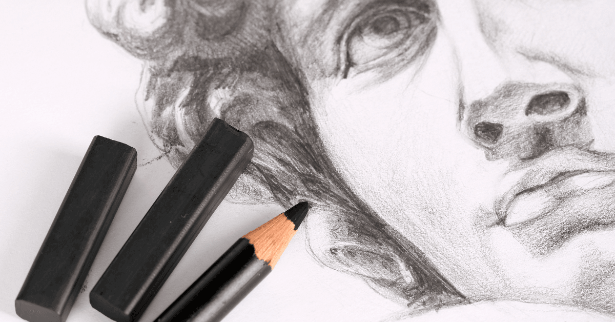 Close-up of a detailed pencil sketch face, symbolizing self-reflection in addiction recovery and art therapy programs; art supplies beside drawing.
