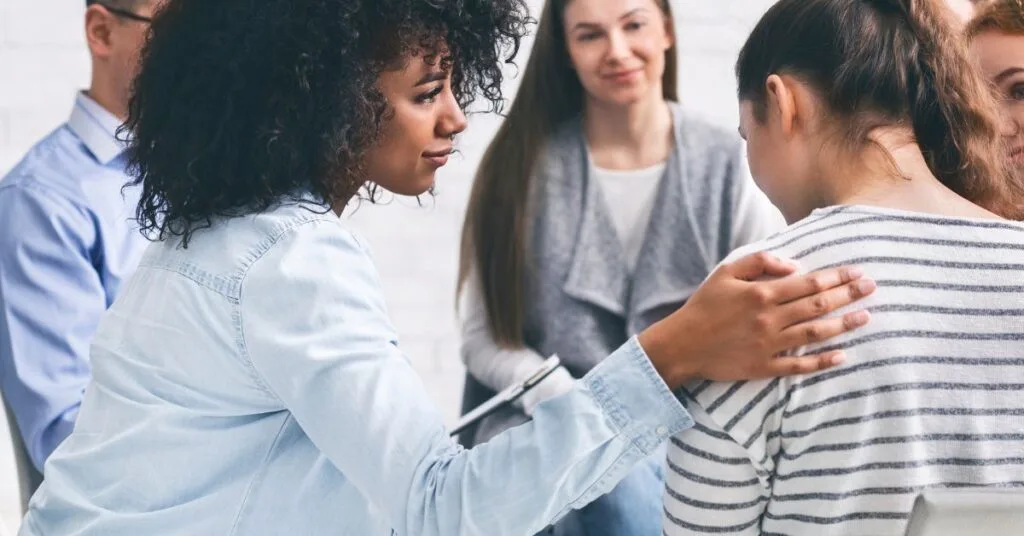 At Crest View Recovery Center, women support each other in a drug and alcohol addiction outpatient group therapy session, representing that they are striving to understand addiction statistics and myths