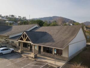 Crest View Recovery Center’s single-story Asheville facility with stone, wood, and large windows offers inviting addiction treatment.