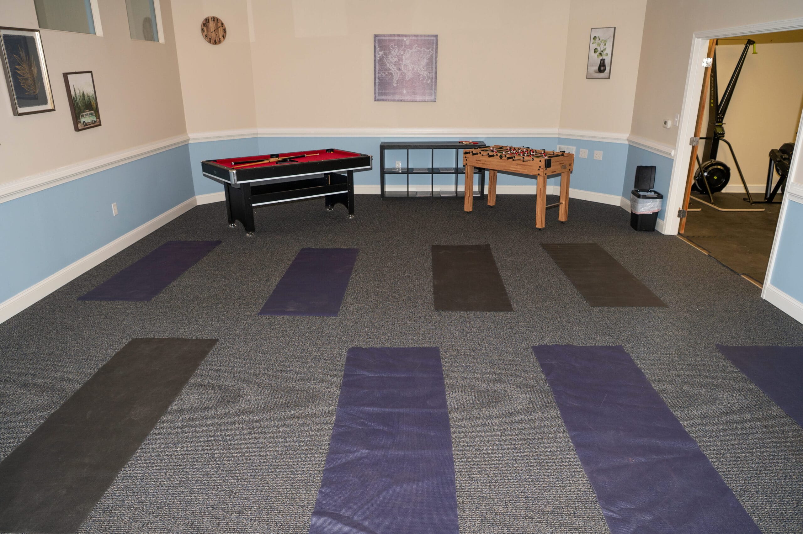 Asheville addiction treatment center room with six yoga mats, air hockey, foosball, exercise gear; ideal for outpatient rehab.