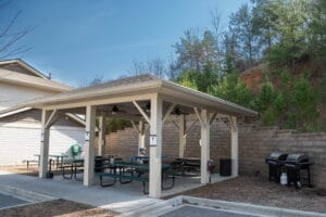 Outdoor pavilion with picnic tables and gas grills near Asheville, ideal for Crest View Recovery Center addiction treatment programs.